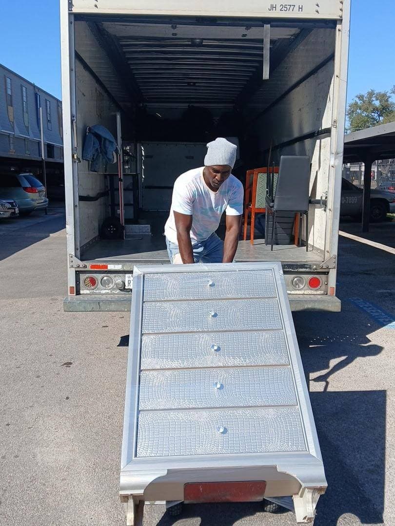 Professional movers handling furniture and moving boxes in Houston