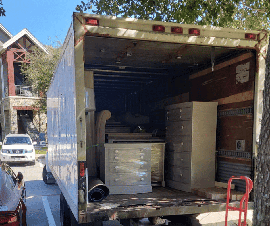 Professional movers handling furniture and moving boxes in Houston